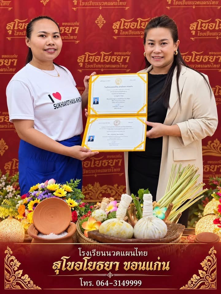 Kru Nuch presents a certificate to a graduate